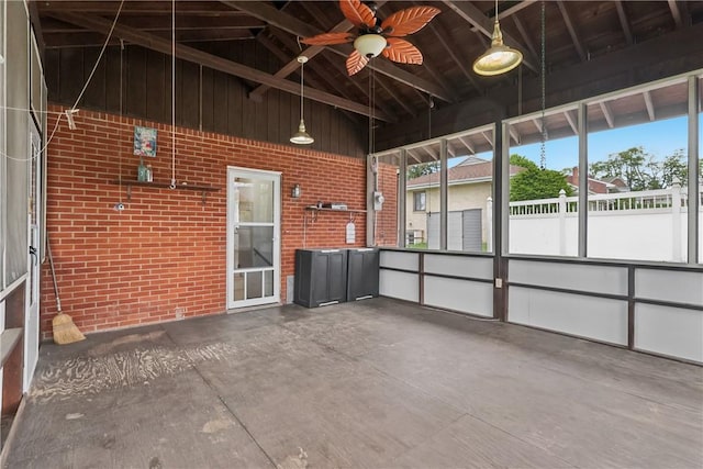 unfurnished sunroom featuring a ceiling fan and lofted ceiling
