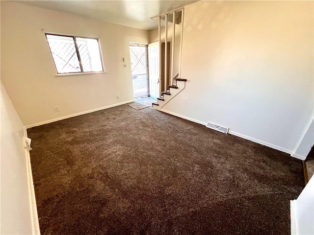 1244 Maple Ave, Monessen, PA 15062 - empty room featuring dark colored carpet, baseboards, and stairway