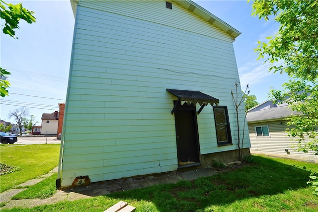 back of house with a lawn