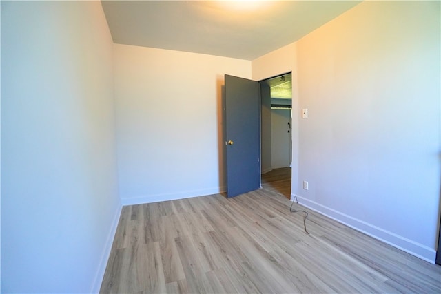 empty room with wood finished floors and baseboards