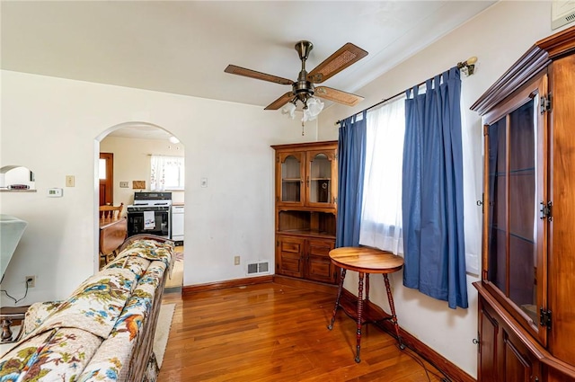 642 Washington St, Fairfield Twp, PA 15923 - living area featuring a ceiling fan, wood finished floors, arched walkways, and baseboards