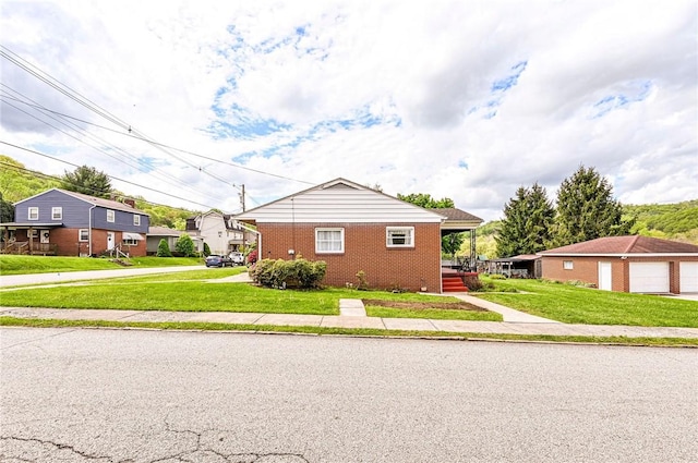 642 Washington St, Fairfield Twp, PA 15923 - view of front facade featuring brick siding, a front yard, and a residential view
