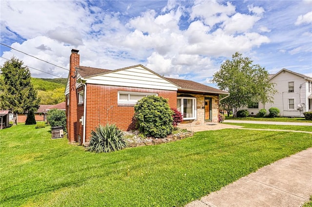 642 Washington St, Fairfield Twp, PA 15923 - bungalow-style home featuring a chimney, a front yard, and brick siding