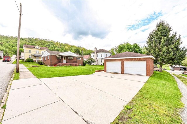642 Washington St, Fairfield Twp, PA 15923 - view of front facade with a detached garage, a front lawn, a residential view, and covered porch