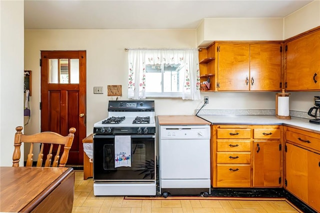 642 Washington St, Fairfield Twp, PA 15923 - kitchen with gas range, dishwasher, plenty of natural light, and brown cabinets