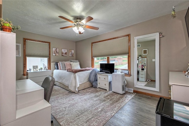 1057 Finchley Rd, North Huntingdon, PA 15642 - bedroom with multiple windows, wood finished floors, a textured ceiling, a desk, and ceiling fan