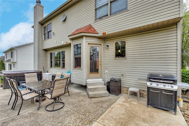 1057 Finchley Rd, North Huntingdon, PA 15642 - back of house with a hot tub, a patio area, entry steps, and a chimney