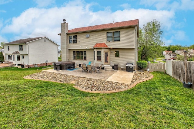 1057 Finchley Rd, North Huntingdon, PA 15642 - back of property featuring a hot tub, entry steps, a patio area, and a chimney