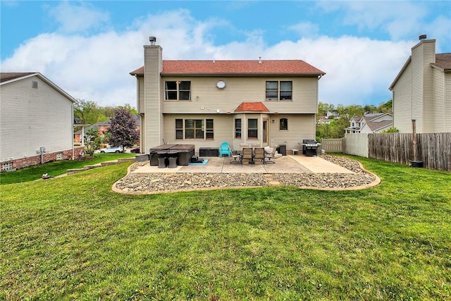 1057 Finchley Rd, North Huntingdon, PA 15642 - back of property featuring a jacuzzi, a patio, and a chimney