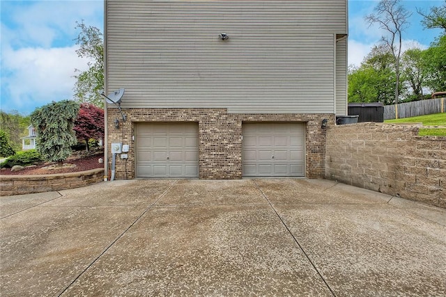 1057 Finchley Rd, North Huntingdon, PA 15642 - garage featuring driveway and fence