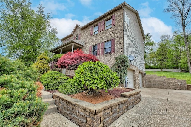 1057 Finchley Rd, North Huntingdon, PA 15642 - view of home's exterior featuring driveway, an attached garage, stone siding, and fence