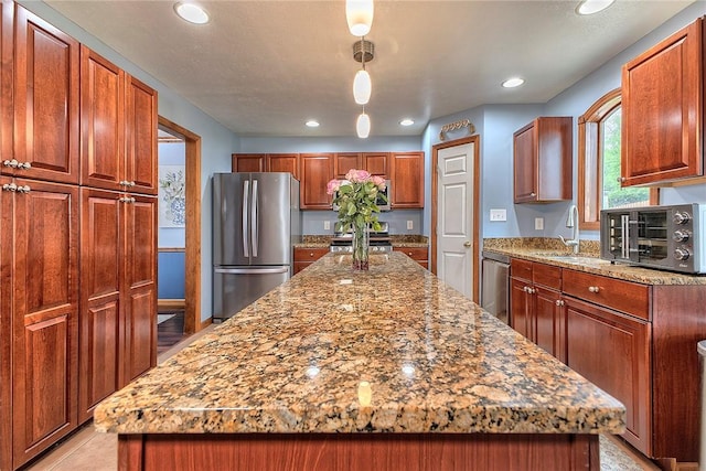 1057 Finchley Rd, North Huntingdon, PA 15642 - kitchen with stainless steel appliances, a sink, a kitchen island, light stone countertops, and recessed lighting