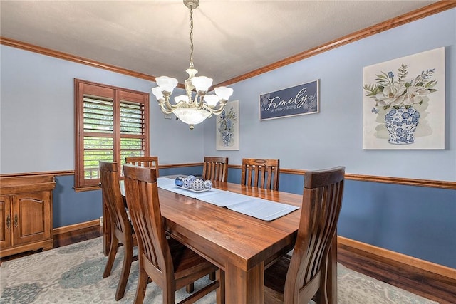 1057 Finchley Rd, North Huntingdon, PA 15642 - dining space with wood finished floors, a chandelier, ornamental molding, and baseboards