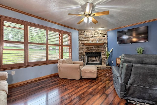 1057 Finchley Rd, North Huntingdon, PA 15642 - living room featuring ornamental molding, dark wood-type flooring, ceiling fan, a stone fireplace, and baseboards