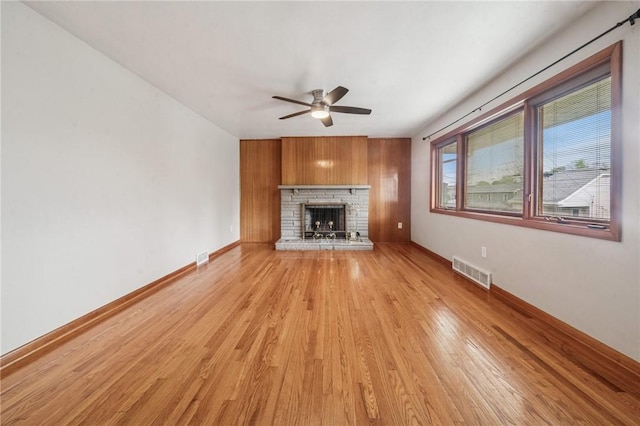329 Sarah St, Mckees Rocks, PA 15136 - unfurnished living room featuring ceiling fan, light wood-style flooring, a stone fireplace, and baseboards