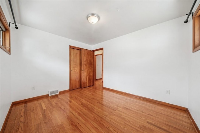 329 Sarah St, Mckees Rocks, PA 15136 - unfurnished bedroom featuring wood finished floors, baseboards, and a closet