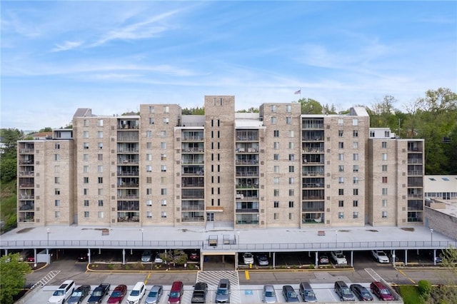 view of apartment building / complex with uncovered parking