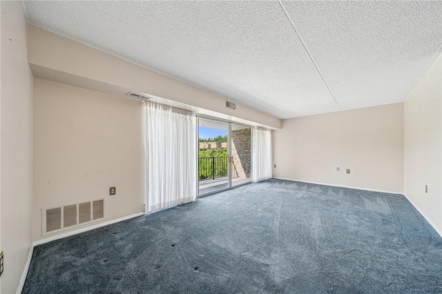 unfurnished room featuring carpet floors, a textured ceiling, and baseboards