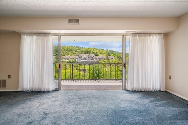 carpeted spare room featuring baseboards