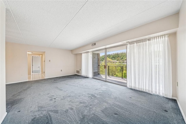 spare room with carpet flooring, a textured ceiling, and baseboards