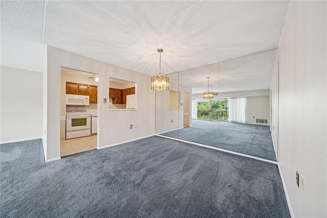 unfurnished dining area featuring a chandelier, carpet floors, a textured ceiling, and baseboards