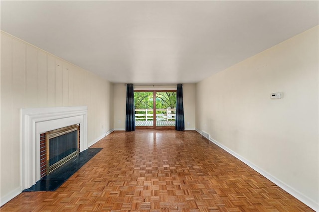 unfurnished living room with baseboards and a fireplace