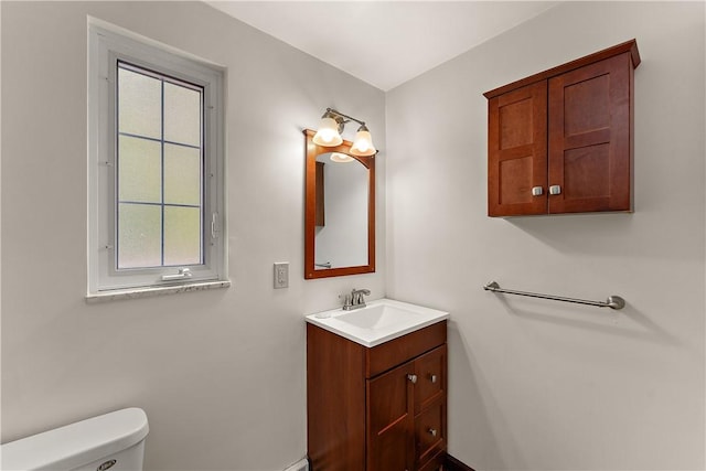 half bath featuring toilet and vanity