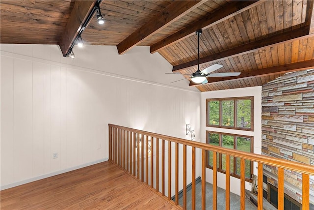 hall featuring track lighting, wood ceiling, wood finished floors, and baseboards