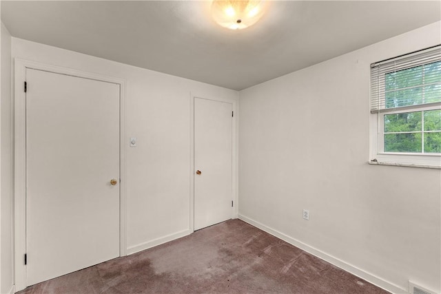 unfurnished bedroom featuring carpet flooring and baseboards