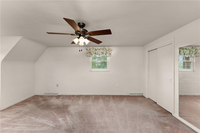 bonus room with carpet floors, a ceiling fan, baseboards, and vaulted ceiling