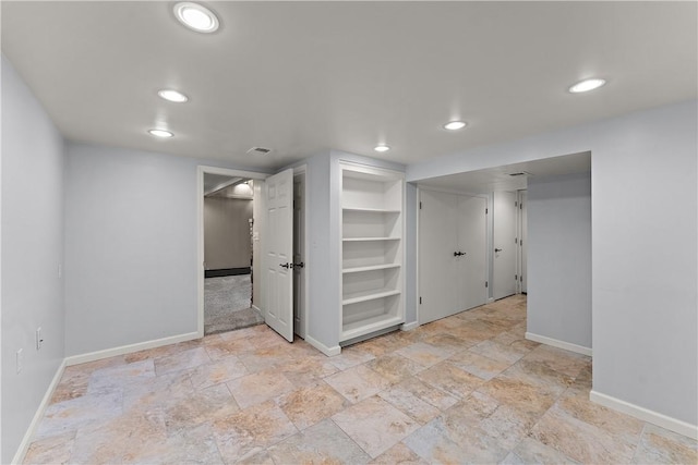 unfurnished room featuring baseboards, recessed lighting, and light stone finish floors