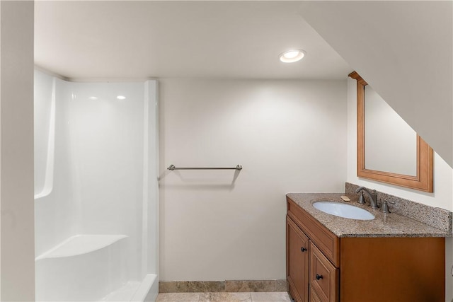 bathroom with vanity, baseboards, a shower, and recessed lighting