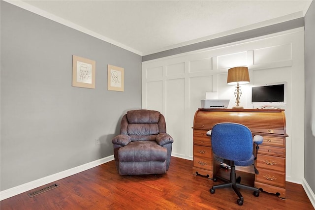 office space with wood finished floors, baseboards, and ornamental molding