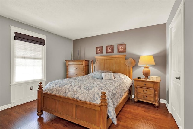 bedroom featuring wood finished floors and baseboards