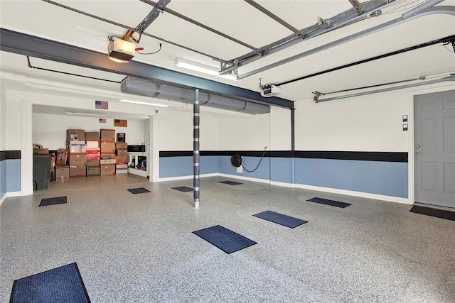garage with a garage door opener and baseboards