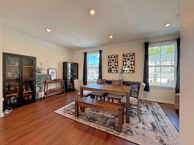 dining area with wood finished floors, baseboards, and recessed lighting