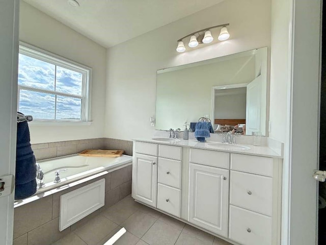 full bath featuring tile patterned floors, a bath, and double vanity