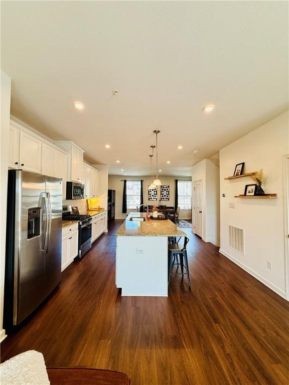159 Cole Dr, Robinson Twp Nwa, PA 15136 - kitchen featuring appliances with stainless steel finishes, dark wood-style flooring, white cabinets, a center island with sink, and recessed lighting