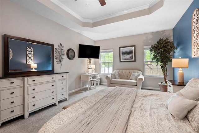 bedroom featuring carpet flooring, a tray ceiling, baseboards, ornamental molding, and a ceiling fan