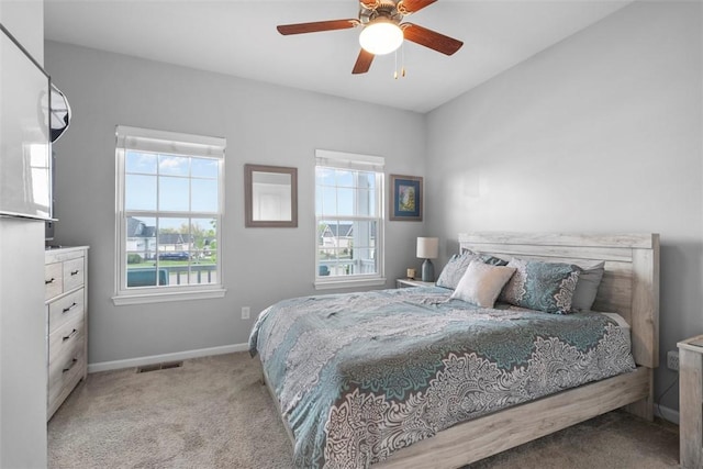 carpeted bedroom featuring baseboards and ceiling fan