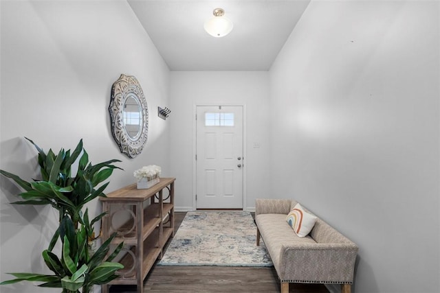 doorway to outside featuring wood finished floors and baseboards