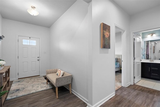 entryway with light wood-type flooring and baseboards