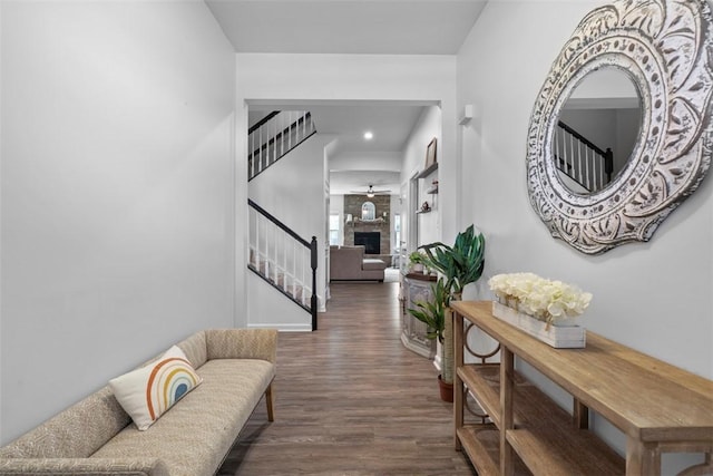 hall with wood finished floors, stairs, and baseboards