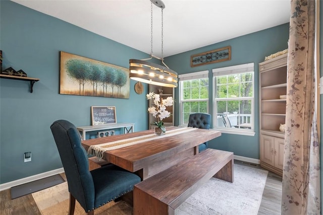 dining area featuring baseboards and wood finished floors