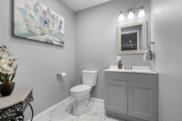 half bath featuring marble look tiles, toilet, baseboards, and vanity