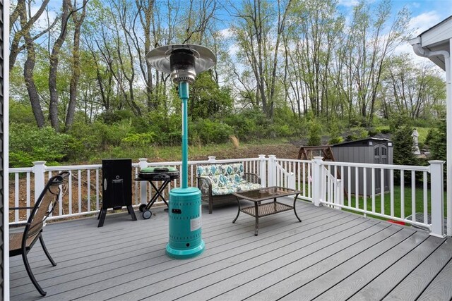 deck with a shed, an outbuilding, and an outdoor living space