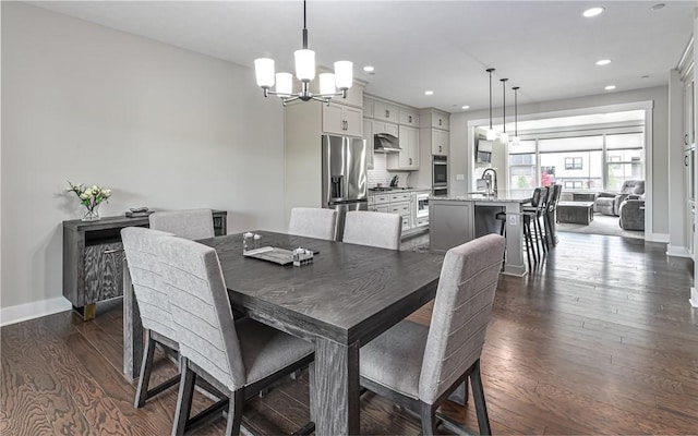 dining area featuring a chandelier, recessed lighting, dark wood-style floors, and baseboards
