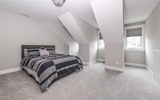 bedroom featuring carpet, lofted ceiling, and baseboards