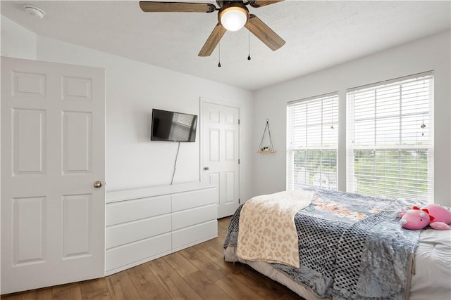 bedroom featuring wood finished floors and a ceiling fan