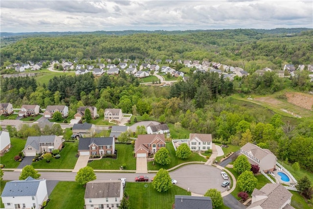 aerial perspective of suburban area with a forest